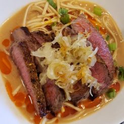 Pan Seared Sirloin over Miso Udon Noodles with Sauerkraut and Chili Sauce